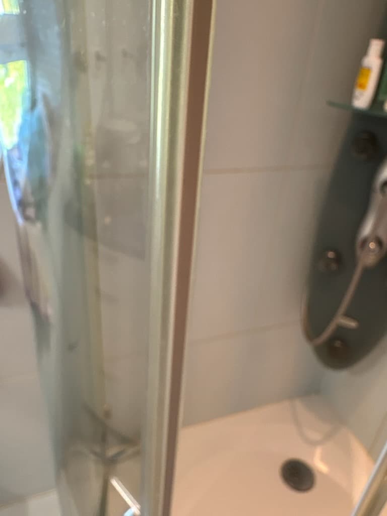 Dolna zużyta uszczelka Dolna część kabiny z widoczną zużytą dolną uszczelką przy brodziku