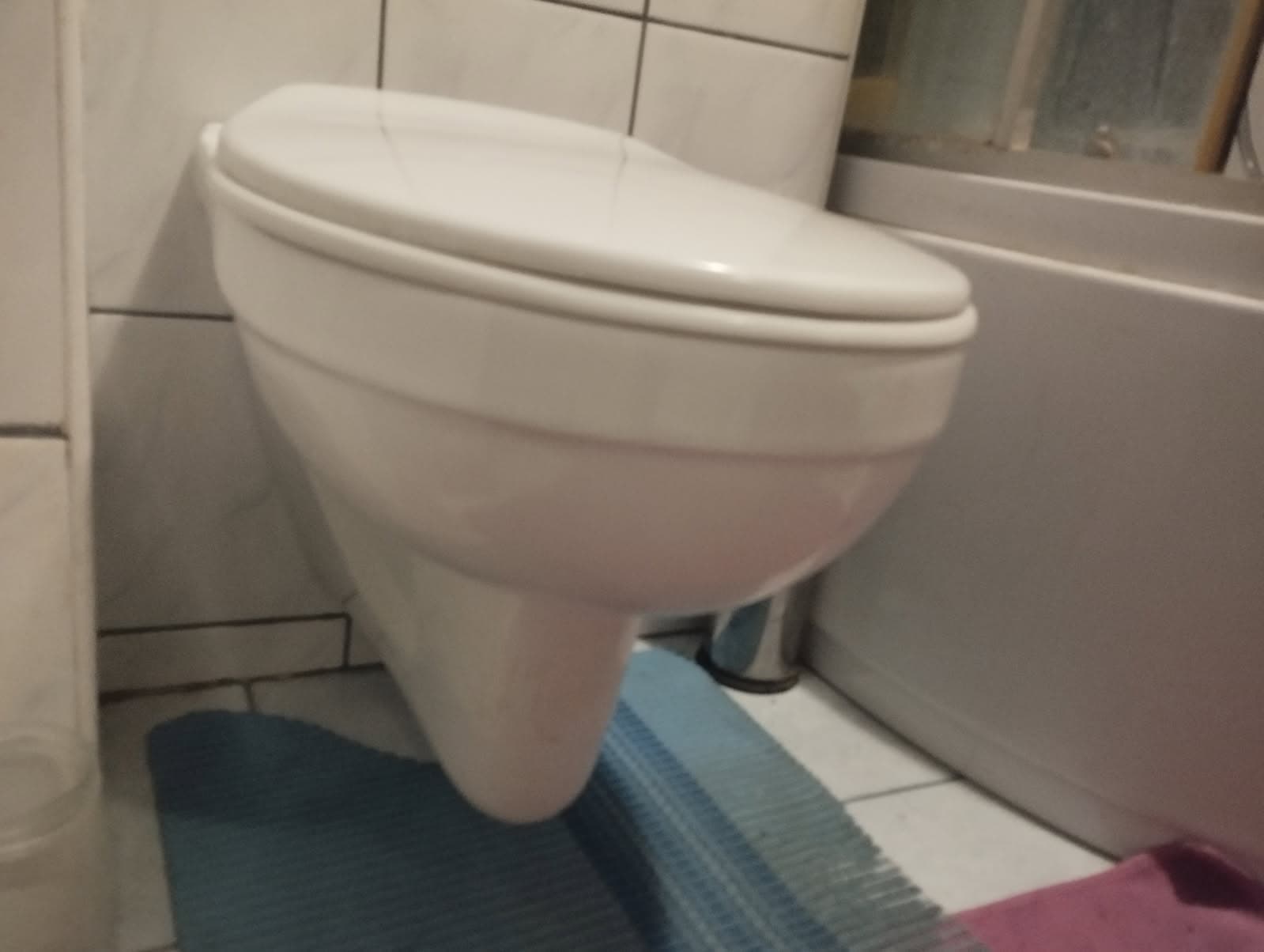 Boczny widok toalety Widok boczny toalety wiszącej zamontowanej przy ścianie.