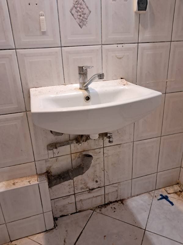 Nowa zamontowana umywalka Nowa umywalka zamontowana na białych płytkach łazienkowych.